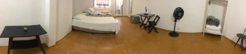 a bedroom with a bed and a wooden floor at Hotel Nobre Requinte in Arujá