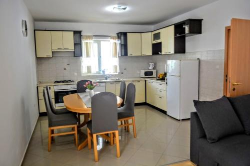 a kitchen and dining room with a table and chairs at Apartments by the sea Brna, Korcula - 10065 in Brna