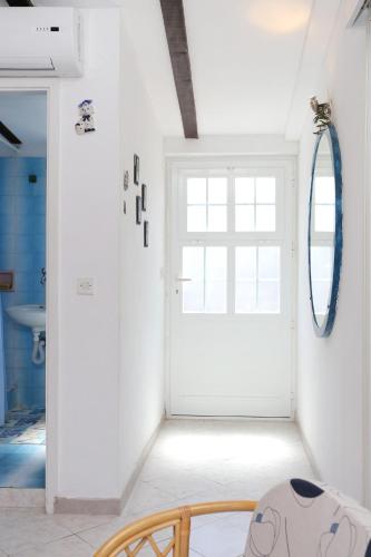 a room with a white door and a mirror at Apartments by the sea Zuljana, Peljesac - 10112 in Žuljana