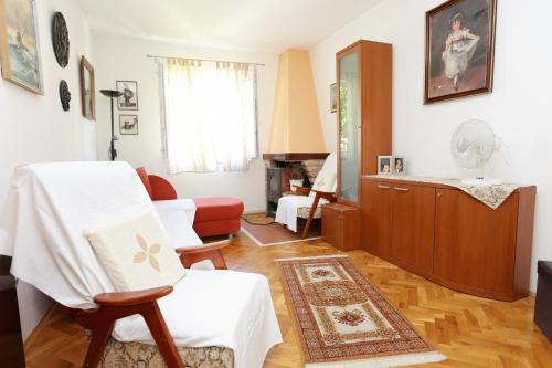 a living room with a chair and a couch at Apartment Zuljana 10112a in Žuljana