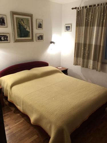 a bedroom with a bed with a blanket on it at Apartment Zuljana 10112a in Žuljana