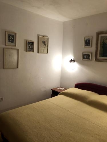a bedroom with a bed and a lamp and pictures on the wall at Apartment Zuljana 10112a in Žuljana