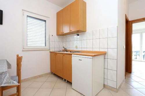 a kitchen with a sink and a counter top at Apartment Drace 10127b in Drače