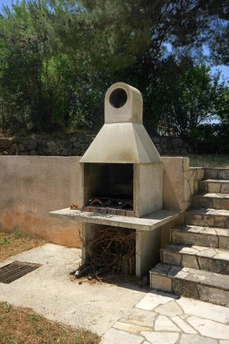 a pizza oven sitting next to some stairs at Apartments and rooms with parking space Orebic, Peljesac - 10191 in Orebić