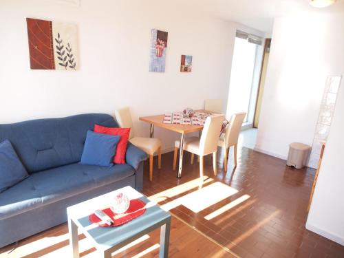 a living room with a blue couch and a table at Apartments and rooms with parking space Orebic, Peljesac - 10192 in Orebić