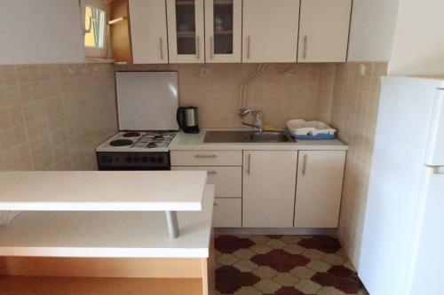 a small kitchen with a sink and a refrigerator at Apartments by the sea Loviste, Peljesac - 10197 in Lovište