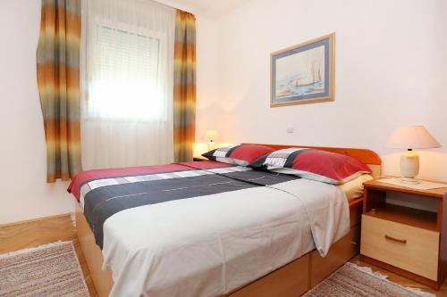 A bed or beds in a room at Holiday apartments Omis - 9492