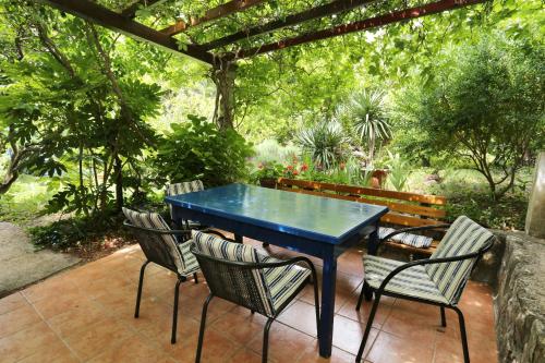 a blue table and chairs on a patio at Secluded fisherman's cottage Ston - Supavao, Peljesac - 9485 in Ston