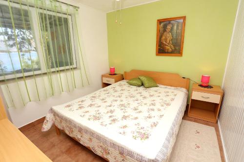 a bedroom with a bed and a window at Apartments by the sea Korcula - 10041 in Korčula