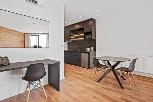a kitchen and dining room with a table and chairs at Grand Suites Lake Tekapo in Lake Tekapo