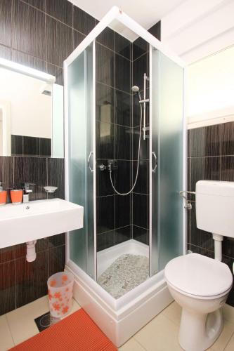 a bathroom with a shower with a toilet and a sink at Holiday house with a parking space Orebic, Peljesac - 9482 in Orebić