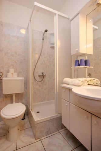 a bathroom with a shower and a toilet and a sink at Apartments with parking space Orebic, Peljesac - 10088 in Orebić