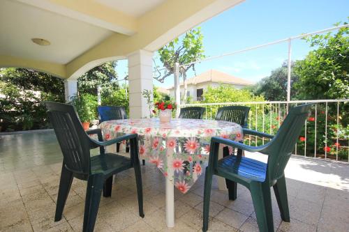 a table with chairs and a tablecloth on a patio at Apartments with a parking space Orebic, Peljesac - 10092 in Orebić