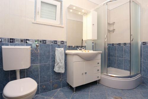 a bathroom with a toilet and a sink and a shower at Apartments by the sea Zuljana, Peljesac - 10207 in Žuljana