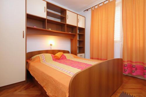 a bedroom with a bed and a book shelf at Apartments with a parking space Orebic, Peljesac - 10177 in Orebić
