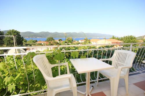 a table and chairs on the balcony of a house at Apartments with parking space Viganj, Peljesac - 10188 in Viganj