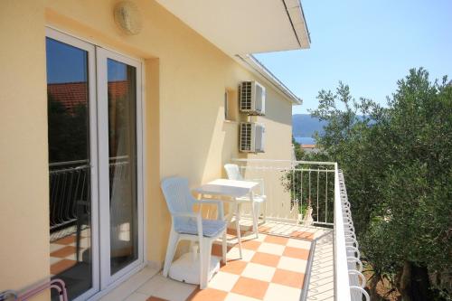 a patio with a table and chairs on a balcony at Apartments with parking space Viganj, Peljesac - 10188 in Viganj