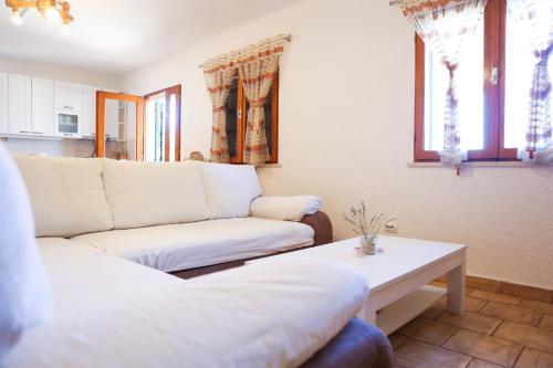 a living room with a couch and a table at Family friendly house with a swimming pool Zavalatica, Korcula - 9476 in Zavalatica