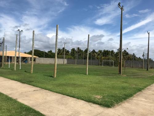 a soccer field with poles in the grass at Villa das aguas -Praia do saco -Próximo as lagoas dos Tambaquis e Mangue Seco -térreo in Estância
