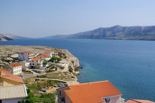 a town on the side of a large body of water at Apartments by the sea Zubovici, Pag - 9678 in Zubovići
