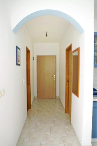 a hallway with two doors and a tile floor at Apartments by the sea Zubovici, Pag - 9678 in Zubovići