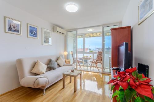 a living room with a couch and a tv at Apartments with WiFi Split - 11660 in Split