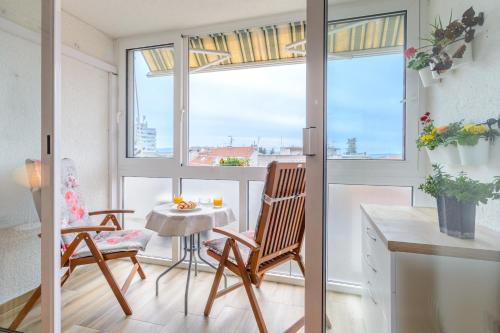 a room with a table and chairs and a window at Apartments with WiFi Split - 11660 in Split