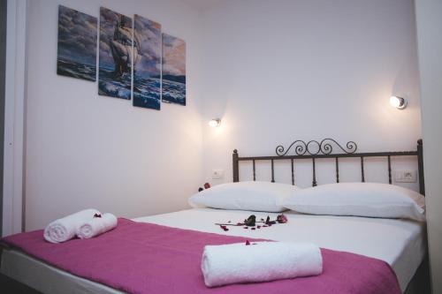 a bedroom with two beds with towels and two pictures at Apartments with a parking space Split - 11690 in Split