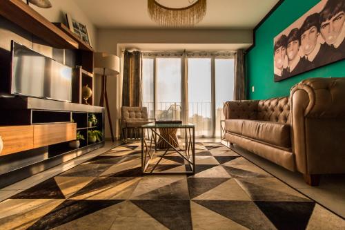 a living room with a couch and a table at NIZA FIVE Luxury Beach Apartments in Puerto Vallarta