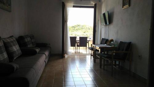 a living room with a couch and a table at Apartments by the sea Kabli, Peljesac - 11695 in Brijesta