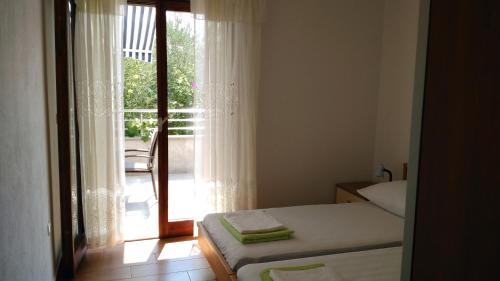 a bedroom with a bed and a sliding glass door at Apartments by the sea Kabli, Peljesac - 11695 in Brijesta