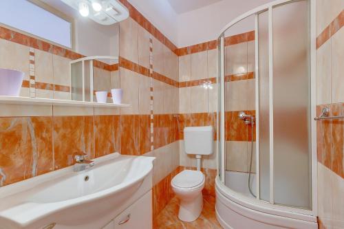 uma casa de banho com um WC, um chuveiro e um lavatório. em Rooms with a parking space Mali Losinj (Losinj) - 9681 em Mali Lošinj