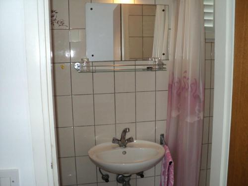 a bathroom with a sink and a mirror at Rooms by the sea Banjol, Rab - 11716 in Rab