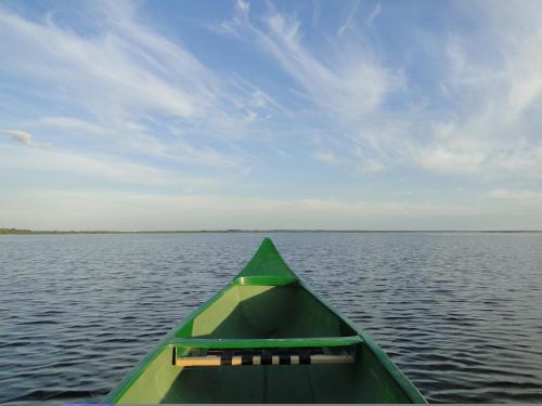 a green boat on a large body of water at Lubāna mitrāja informācijas centrs in Abaine