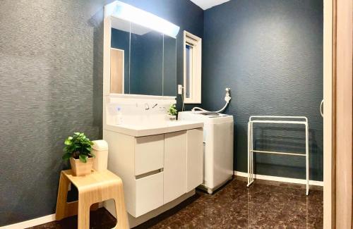 a bathroom with a white sink and a mirror at DAISHO - Vacation STAY 36303v in Hokuto