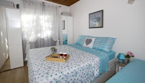 a bedroom with a bed with a box on it at Apartments by the sea Brela, Makarska - 11821 in Brela