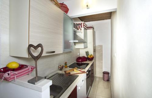 a kitchen with a sink and a counter top at Apartments by the sea Brela, Makarska - 11821 in Brela