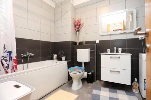 a bathroom with a toilet and a tub and a sink at Apartments with a parking space Split - 11863 in Split