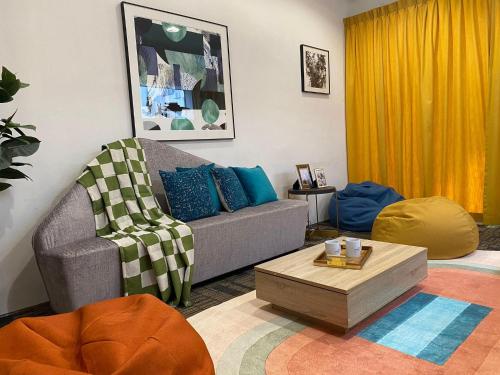 a living room with a couch and a coffee table at The Assembly Place, A Co-living at Mayo in Singapore