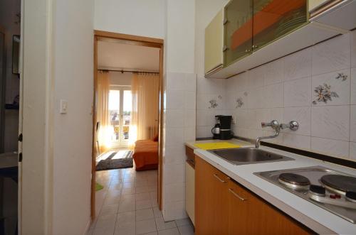 a kitchen with a sink and a counter top at Apartments with a parking space Orebic, Peljesac - 12041 in Orebić