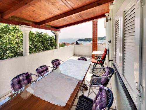 a patio with a table and chairs on a balcony at Apartments by the sea Prvic Luka, Prvic - 12064 in Prvić Luka