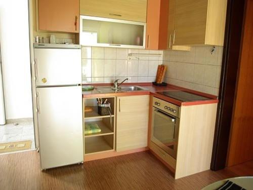 a kitchen with a white refrigerator and a sink at Apartments with a parking space Murter - 12067 in Murter