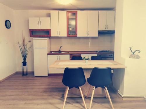 a kitchen with white cabinets and two blue chairs at Apartments and rooms by the sea Nevidjane, Pasman - 11902 in Neviđane