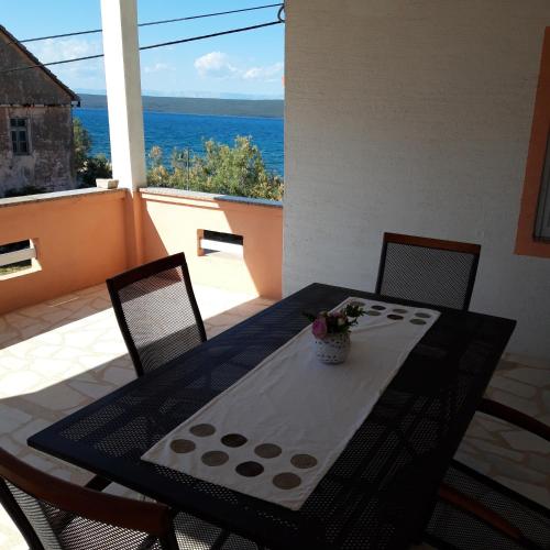 a black table and chairs with a view of the ocean at Apartments and rooms by the sea Nevidjane, Pasman - 11902 in Neviđane