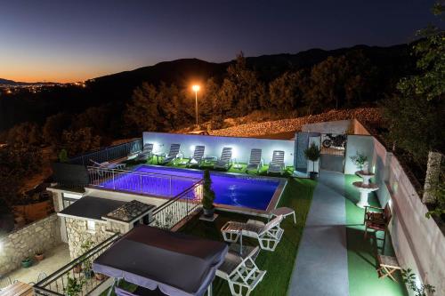 a backyard with a swimming pool at night at Apartment Crikvenica 12116a in Crikvenica