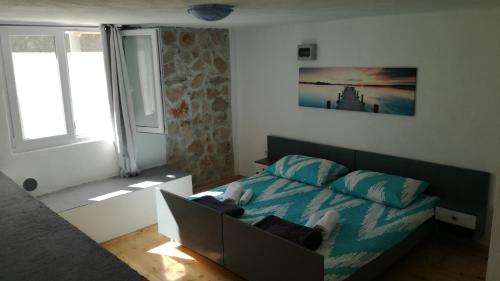 a bedroom with a bed and a window at Seaside house for families with children Cove Vitane, Pasman - 12141 in Tkon