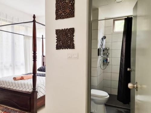 a bathroom with a shower and a toilet at Mossy Forest Family Retreat, Kea Farm Brinchang in Brinchang