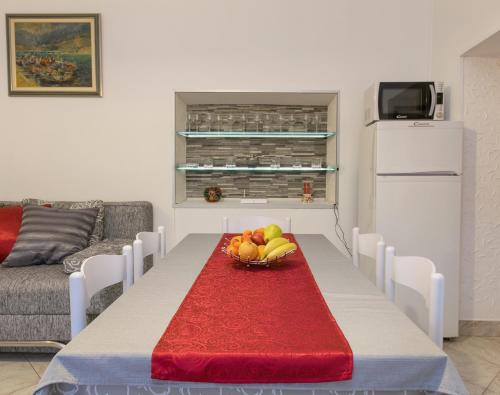 a living room with a table with a bowl of fruit at Apartments by the sea Baska Voda, Makarska - 12209 in Baška Voda