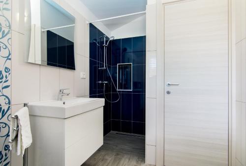 a bathroom with a sink and a shower at Family friendly house with a swimming pool Krsan - Vlasici, Central Istria - Sredisnja Istra - 12224 in Kršan