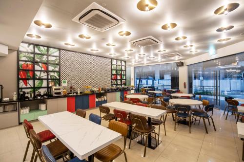 a dining room with tables and chairs in a restaurant at ibis Styles Singapore Albert in Singapore